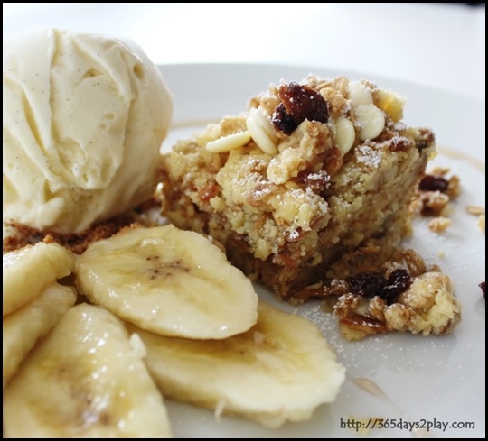 Robolots - Layers of ripened banana bread stack made with milk, honey, cinnamon, raisins and chocolate chips, served with a scoop of vanilla gelato