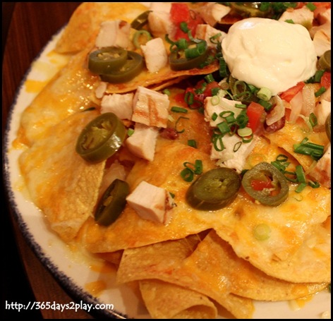 Hard Rock Cafe - Fresh corn tortilla chips piled high with Jack & Cheddar cheeses and seasoned pinto beans with addition of chicken