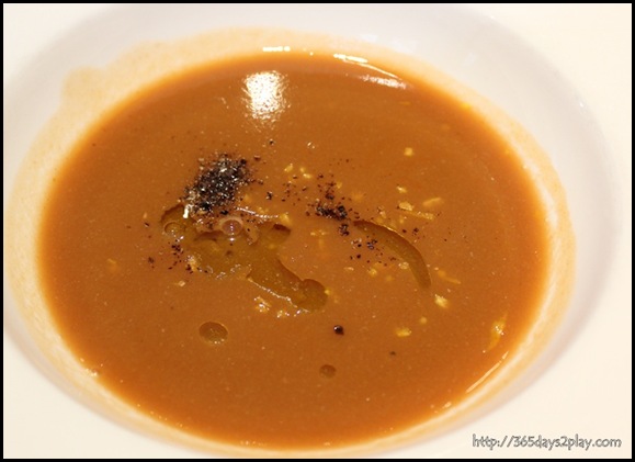 Oso Ristorante - Hot seafood cioppino bisque soup with grated orange skin