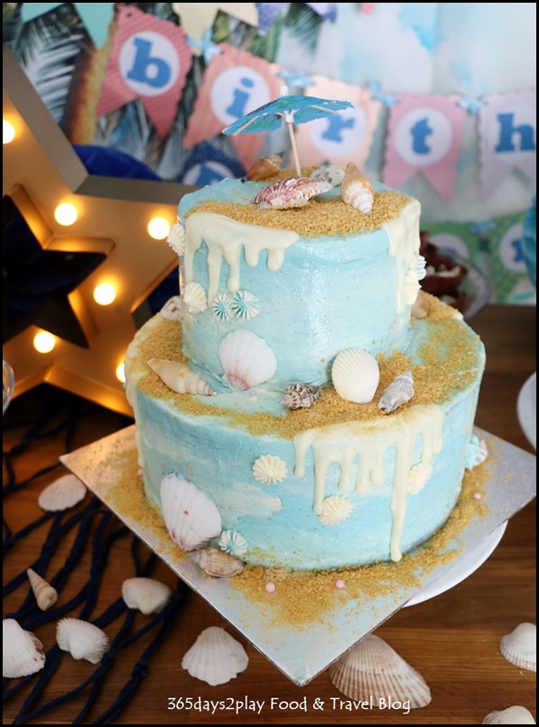 Seaside-themed drips birthday cake