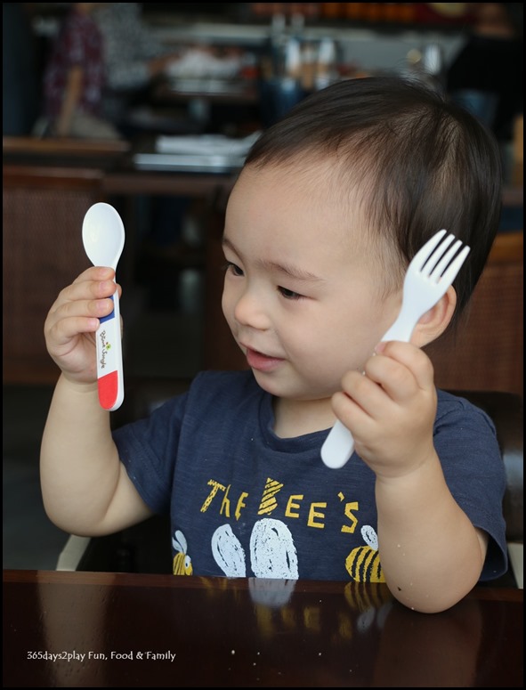 Toddler playing with utensils